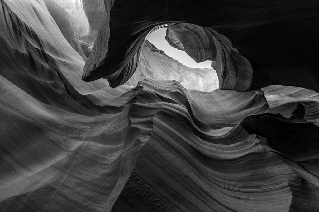 Black and white photograph of flowing sandstone formations inside Antelope Canyon, Arizona
