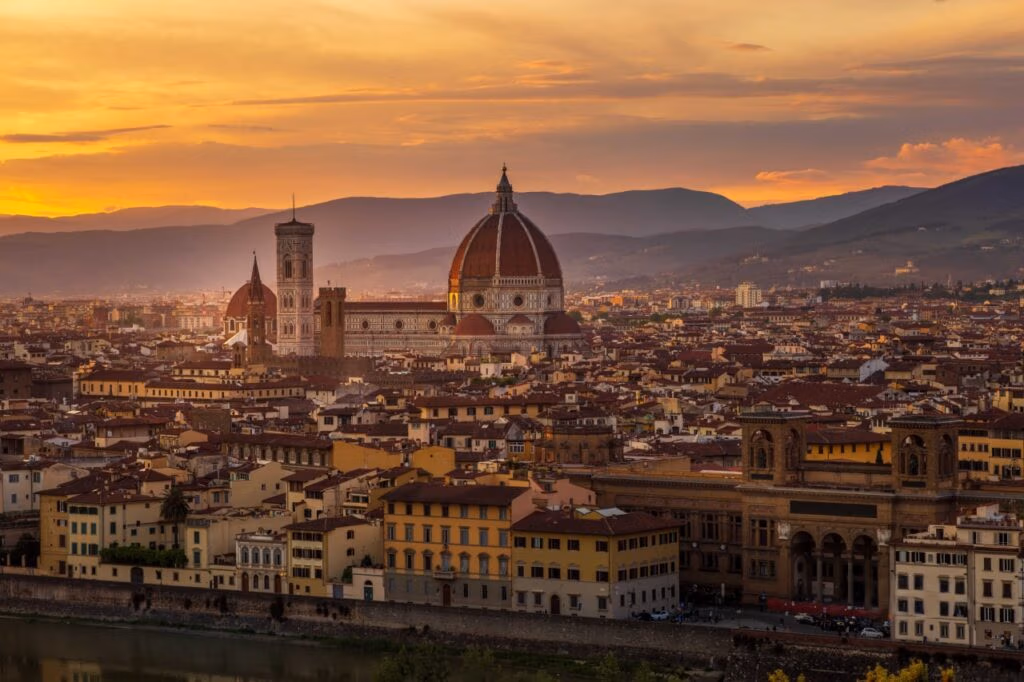 Sunset over Florence, Italy, with the Cathedral of Santa Maria del Fiore, historic rooftops and Tuscan hills